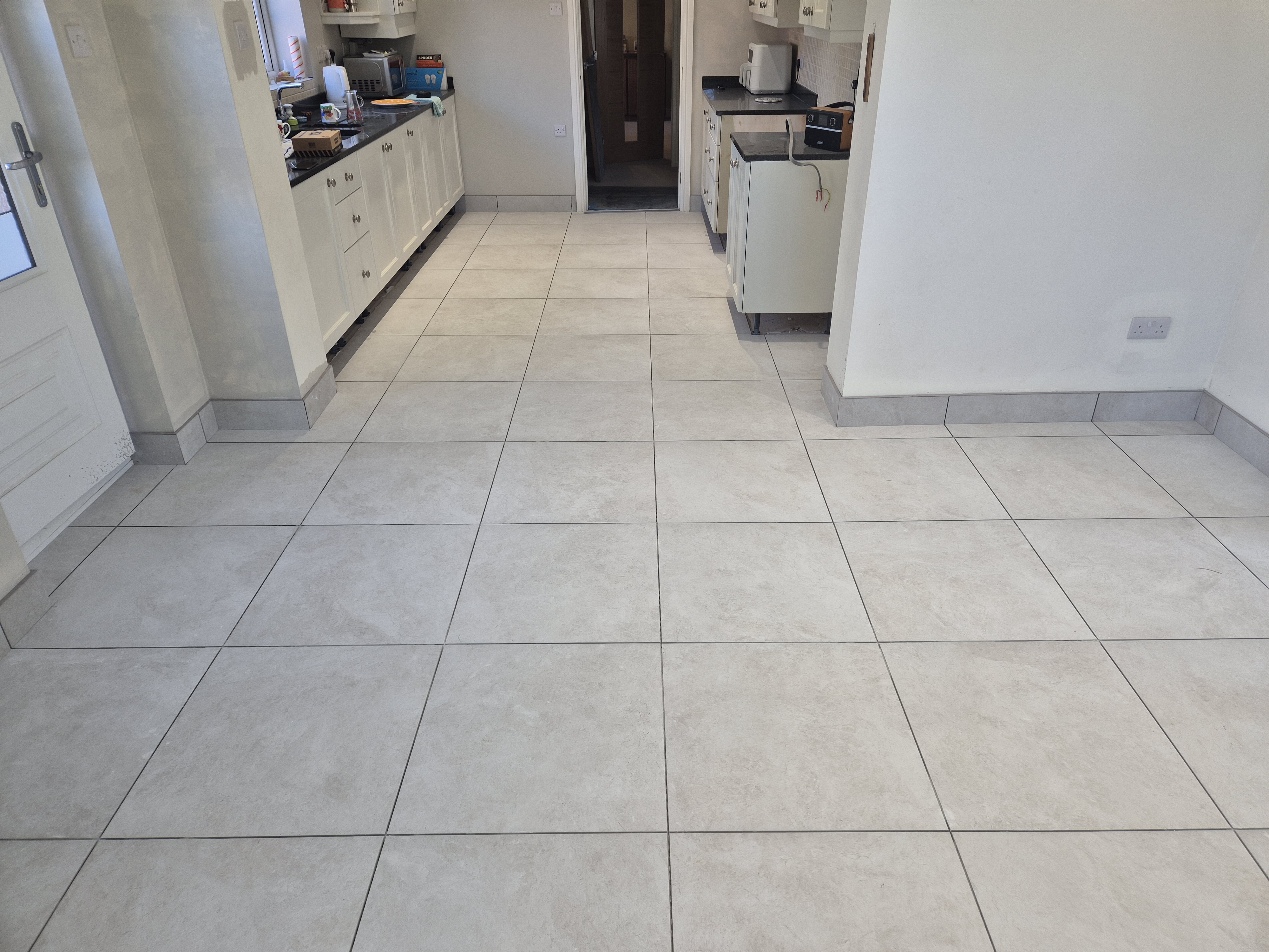 Original uneven 300x300 floor tiles being removed in Frodsham kitchen