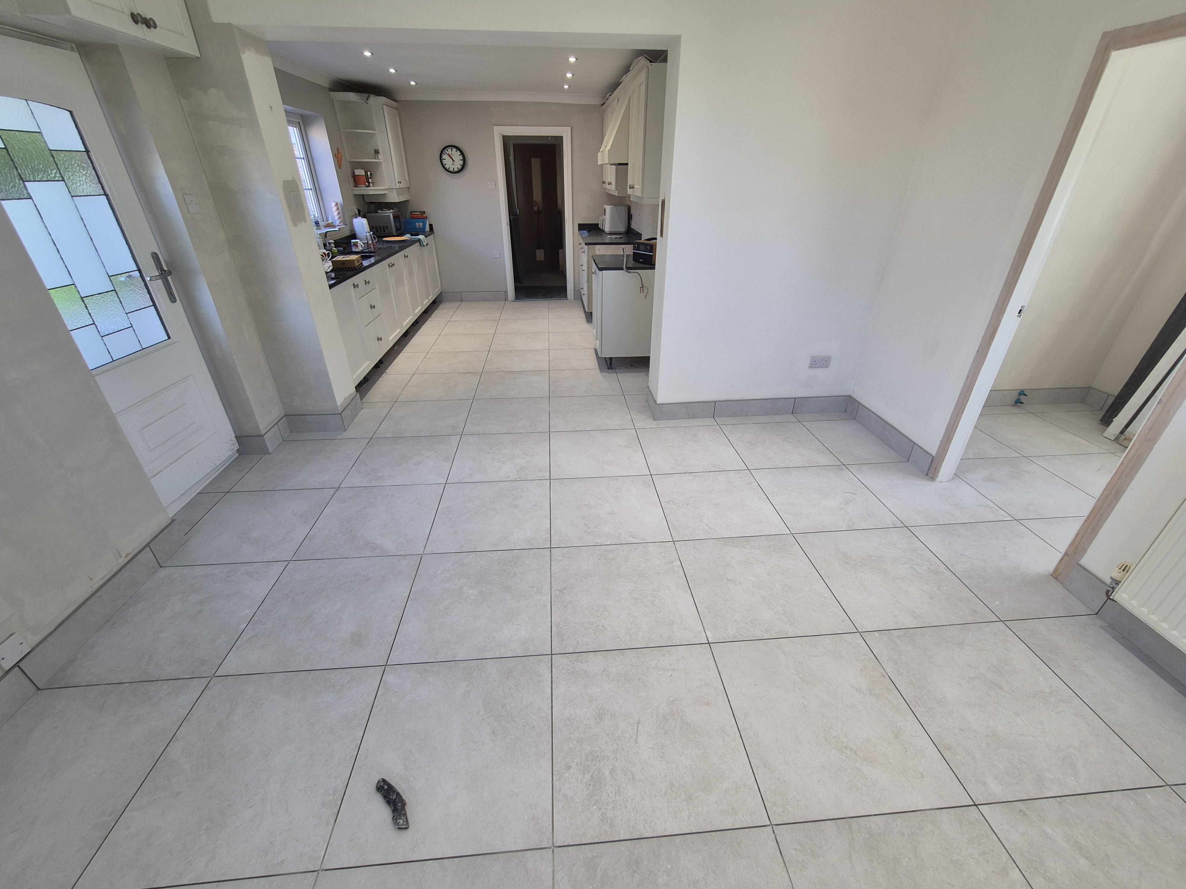 Old kitchen floor tiles stripped back ready for preparation in Frodsham